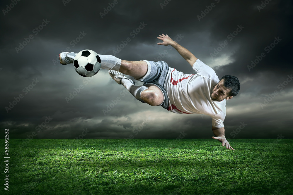 Fototapeta Football player with ball in